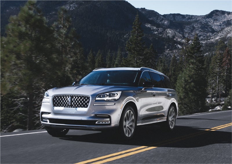 A 2023 Lincoln Aviator® Grand Touring SUV being driven on a winding road to demonstrate the capabilities of all-wheel drive | Dave Sinclair Lincoln St. Peters in Saint Peters MO