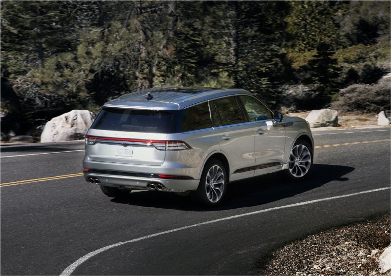 A 2023 Lincoln Aviator® Grand Touring model is shown being driven on a tight turn of a mountain road | Dave Sinclair Lincoln St. Peters in Saint Peters MO