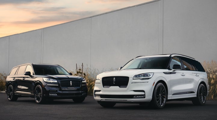 Two Lincoln Aviator® SUVs are shown with the available Jet Appearance Package | Dave Sinclair Lincoln St. Peters in Saint Peters MO