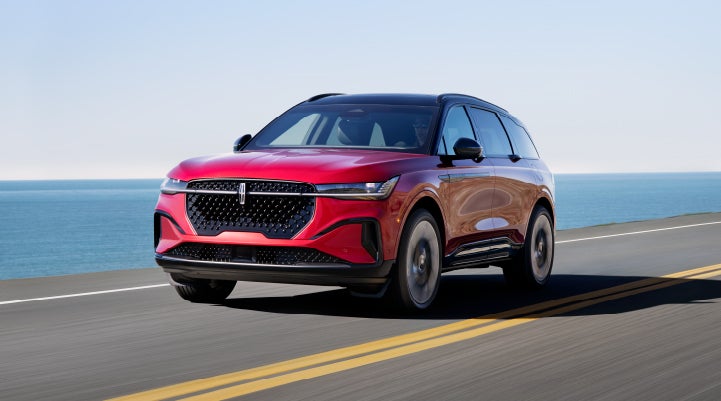 A 2024 Lincoln Nautilus® SUV is being driven on a seaside roadway. | Dave Sinclair Lincoln St. Peters in Saint Peters MO