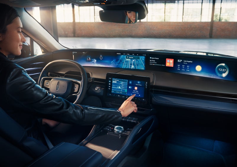 The driver of a 2025 Lincoln Nautilus® SUV interacts with the center touchscreen. | Dave Sinclair Lincoln St. Peters in Saint Peters MO