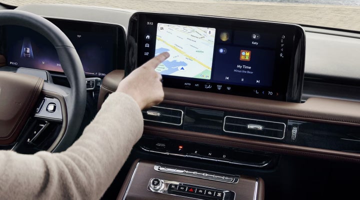 A person is tapping the center display touchscreen of a 2026 Lincoln Aviator® SUV. | Dave Sinclair Lincoln St. Peters in Saint Peters MO