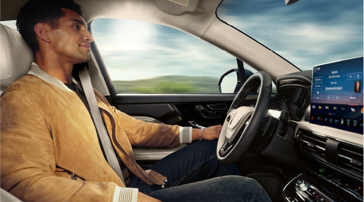 A person is shown using Lincoln BlueCruise hands-free highway driving technology on a divided highway in a hands-free Blue Zone. | Dave Sinclair Lincoln St. Peters in Saint Peters MO