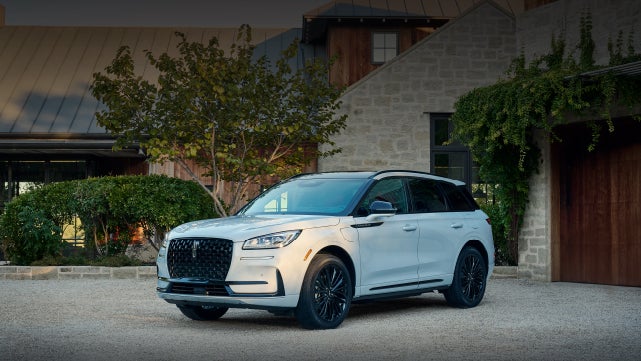 A 2026 Lincoln Corsair® SUV is parked in front off a luxury home. | Dave Sinclair Lincoln St. Peters in Saint Peters MO
