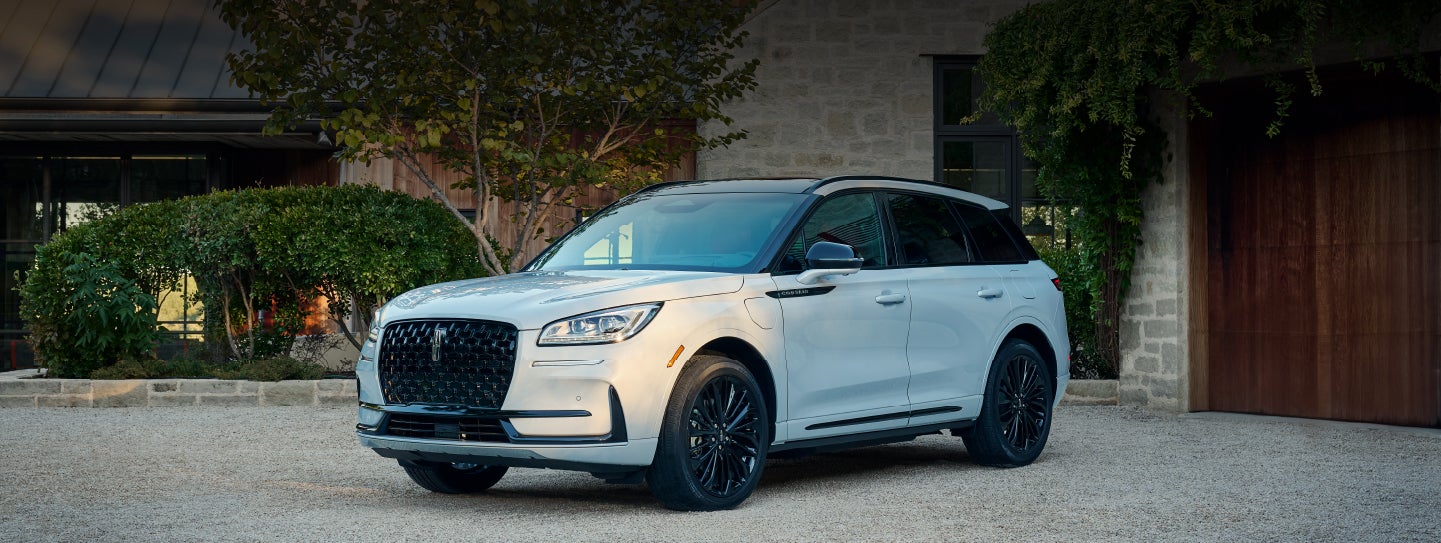 A 2026 Lincoln Corsair® SUV is parked in front off a luxury home. | Dave Sinclair Lincoln St. Peters in Saint Peters MO