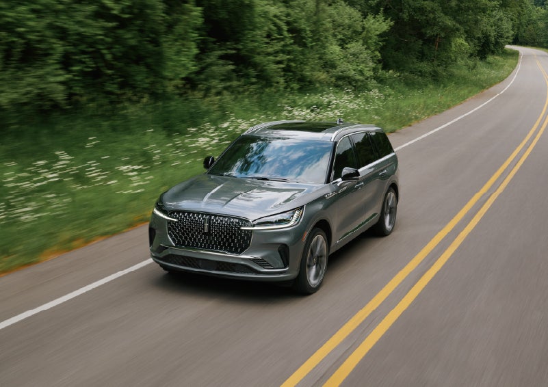 A 2027 Lincoln Aviator® SUV is being driven down a road. | Dave Sinclair Lincoln St. Peters in Saint Peters MO