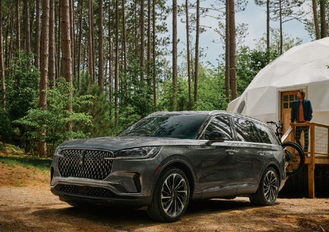 A 2027 Lincoln Aviator® is parked next to a high end glamping site. | Dave Sinclair Lincoln St. Peters in Saint Peters MO