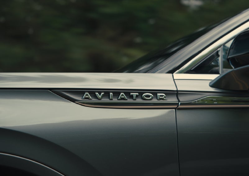 The driver’s side door and fender badging of a gray 2027 Lincoln Aviator® SUV are showcased. | Dave Sinclair Lincoln St. Peters in Saint Peters MO