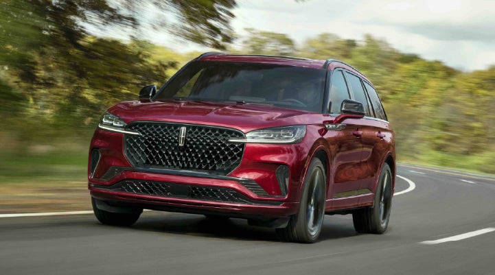 A 2027 Lincoln Aviator® SUV is being driven on a country road | Dave Sinclair Lincoln St. Peters in Saint Peters MO