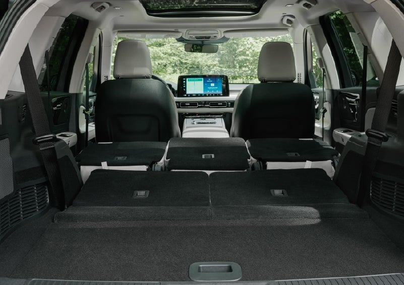 A rear to front view of the interior of a 2027 Lincoln Aviator® Black Label™ SUV shows the third and second rows folded flat | Dave Sinclair Lincoln St. Peters in Saint Peters MO