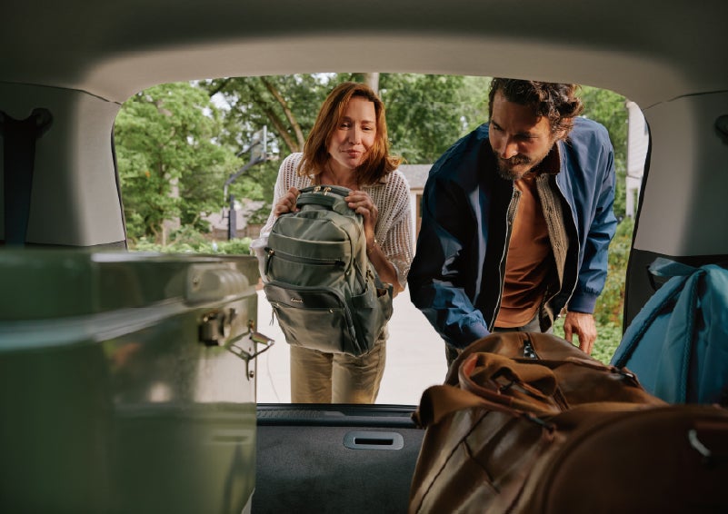 A couple loads luggage into the rear of a 2027 Lincoln Aviator® Black Label™ SUV..e 202 | Dave Sinclair Lincoln St. Peters in Saint Peters MO