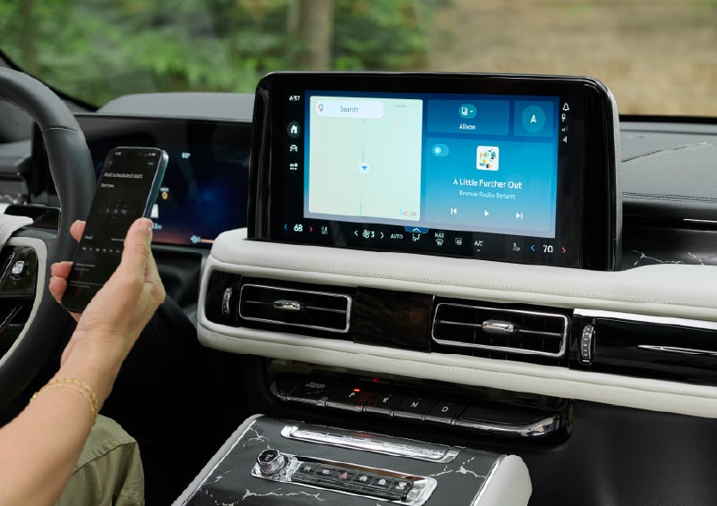 A person pairs thier phone with the center touchscreen of a 2027 Lincoln Aviator® Black Label™ SUV | Dave Sinclair Lincoln St. Peters in Saint Peters MO