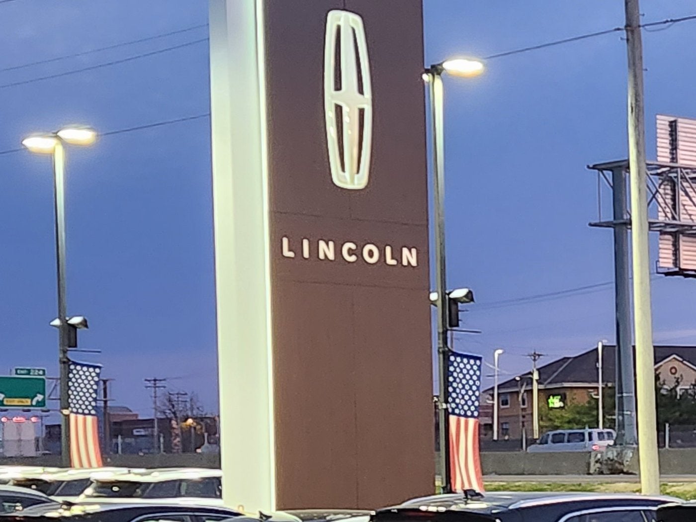Vehicles on the lot beside the Lincoln star sign at Dave Sinclair Lincoln St. Peters