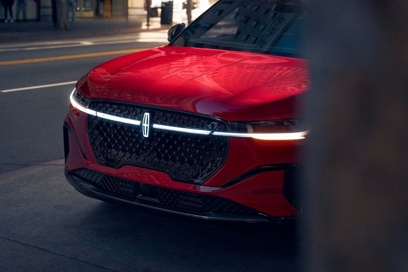 Front of a red Lincoln Nautilus with the grille and lit light bar